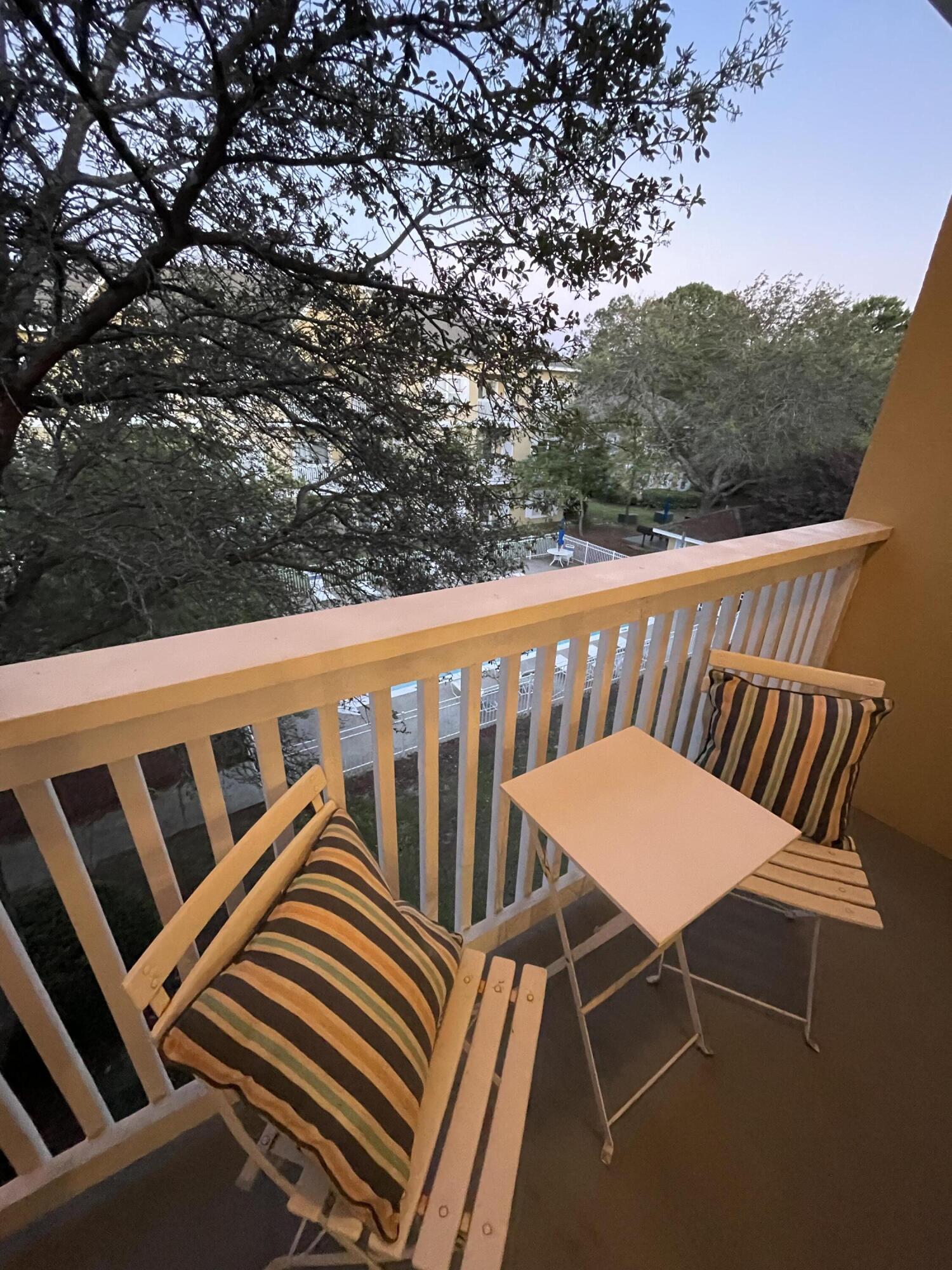 34 Heron's Watch Way, Unit 2304 Santa Rosa Beach, FL 32459 - Photo 27 of 56 a view of a balcony with table and chairs