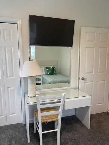 a bedroom with a bed and a night stand