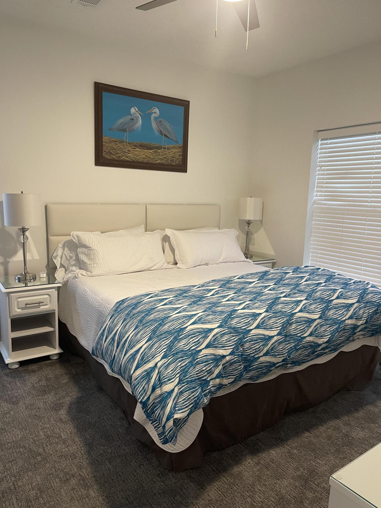 34 Heron's Watch Way, Unit 2304 Santa Rosa Beach, FL 32459 - Photo 32 of 56 a bedroom with a bed and a night stand