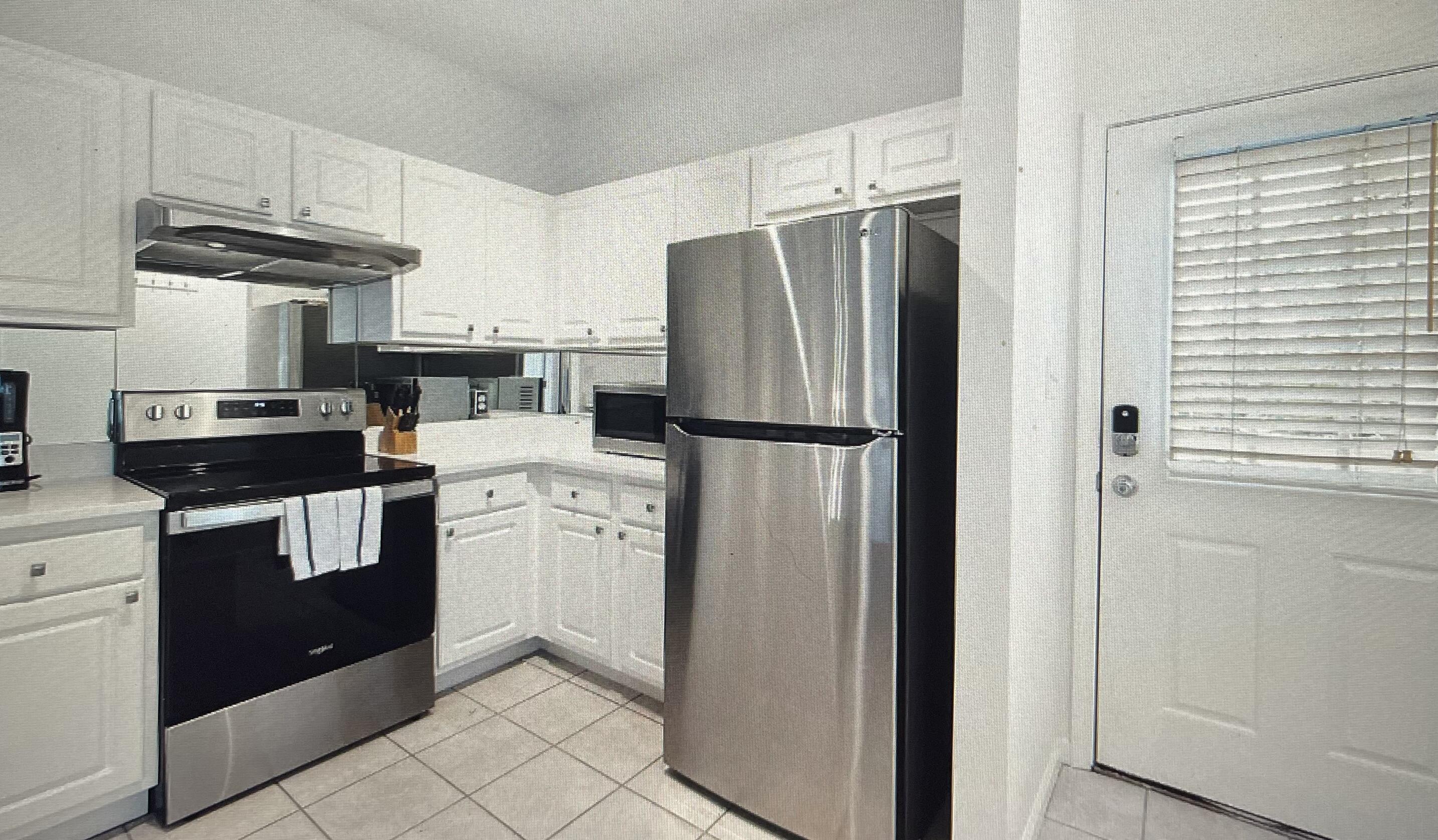 34 Heron's Watch Way, Unit 2304 Santa Rosa Beach, FL 32459 - Photo 6 of 56 a kitchen with a refrigerator sink and cabinets