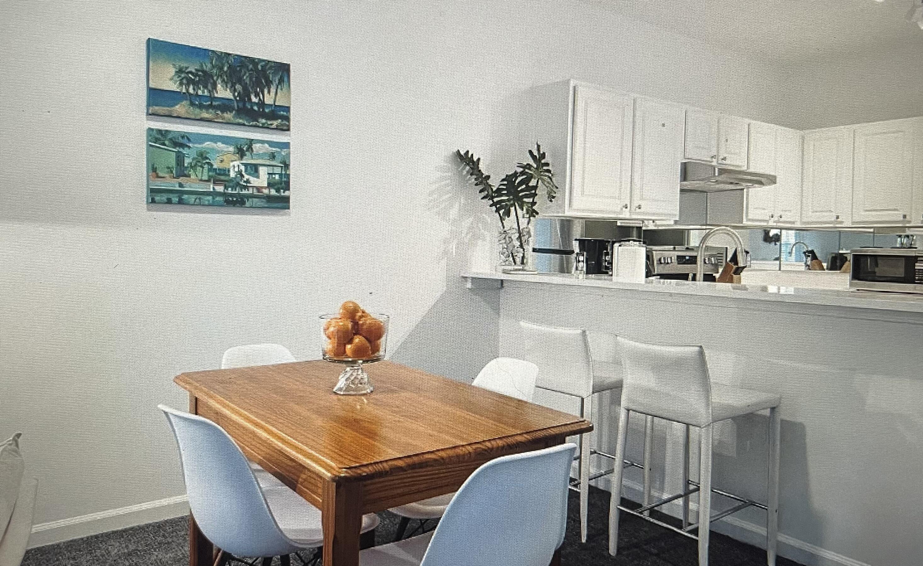 34 Heron's Watch Way, Unit 2304 Santa Rosa Beach, FL 32459 - Photo 8 of 56 a kitchen with stainless steel appliances a white table chairs and a refrigerator