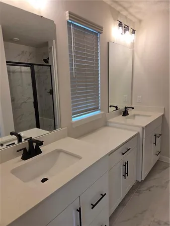 a bathroom with a glass shower door