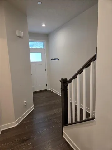 a view of a hallway with wooden floor