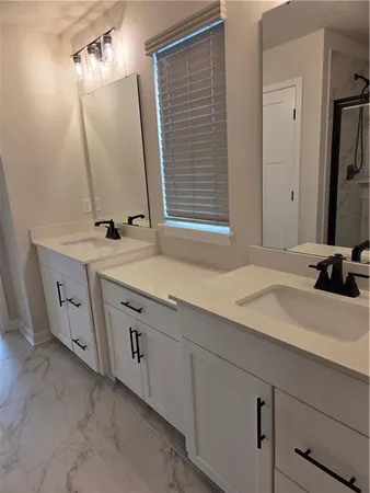 a bathroom with a shower a toilet and sink