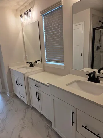 a bathroom with a shower a toilet and sink