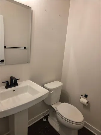 a white toilet sitting next to a white sink