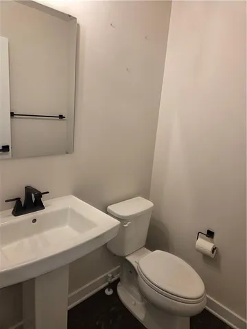 a white toilet sitting next to a white sink