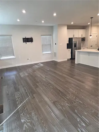 an open kitchen with white cabinets and stainless steel appliances
