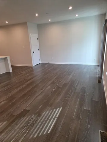 a view of room with wooden floor