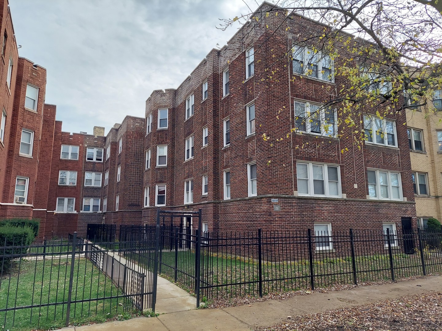 5027 North Harding Avenue, Unit 2W Chicago, IL 60625 - Photo 1 of 20 a view of a brick building next to a yard