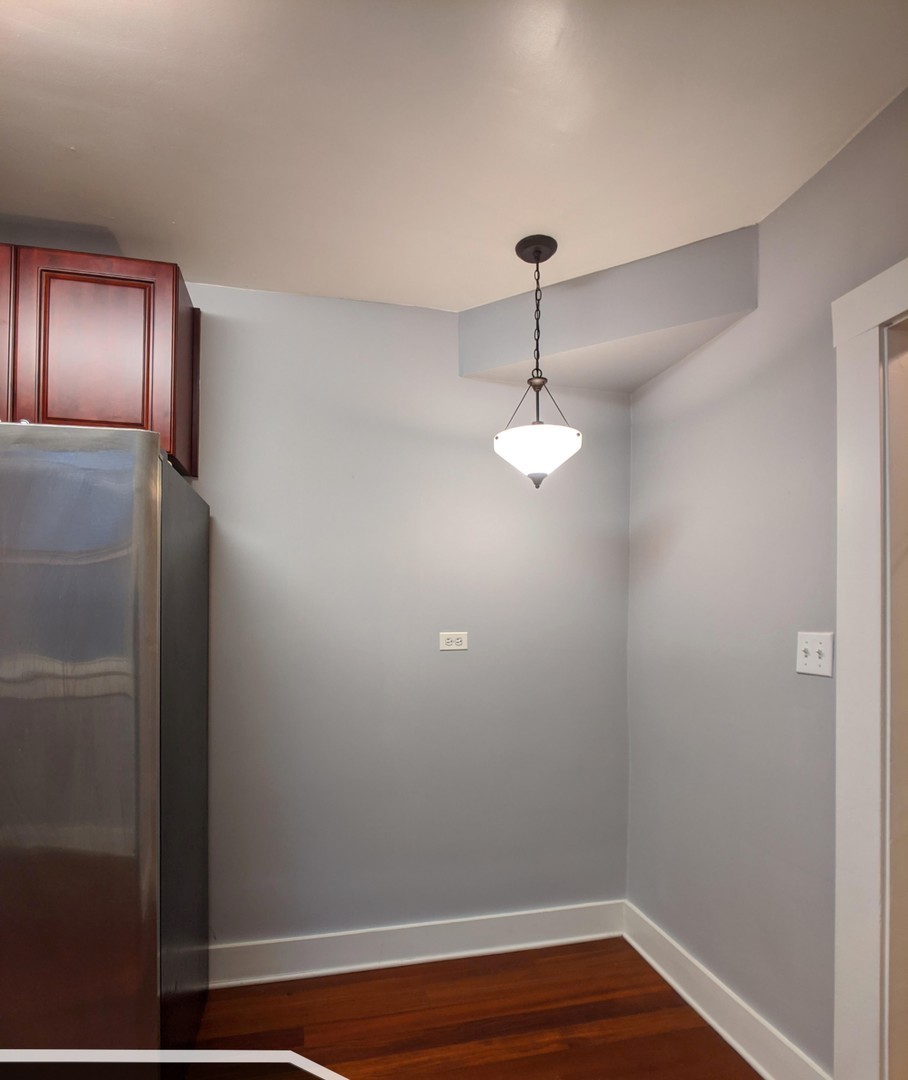 5027 North Harding Avenue, Unit 2W Chicago, IL 60625 - Photo 11 of 20 a view of empty room with wooden floor