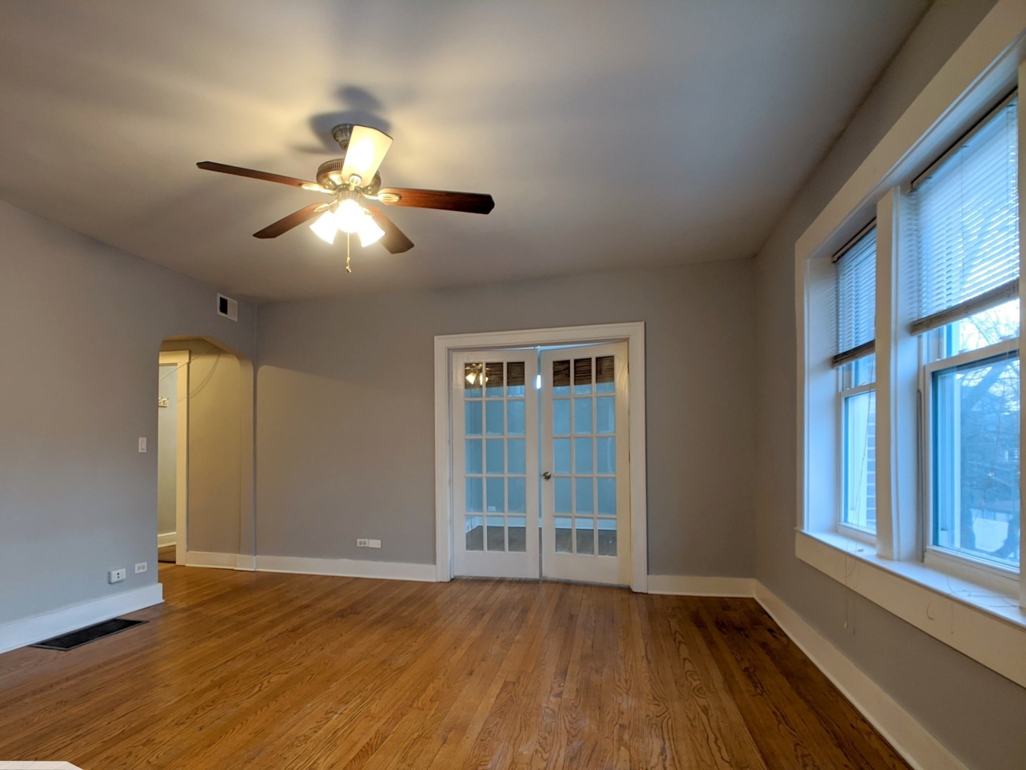 5027 North Harding Avenue, Unit 2W Chicago, IL 60625 - Photo 4 of 20 a view of an empty room with wooden floor and a window