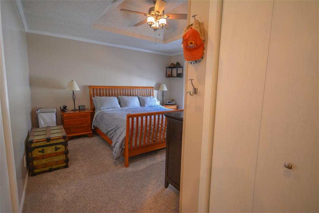 257 Huron Road, Unit E24 Breckenridge, CO 80424 - Photo 18 of 29 a bedroom with a bed and a chandelier
