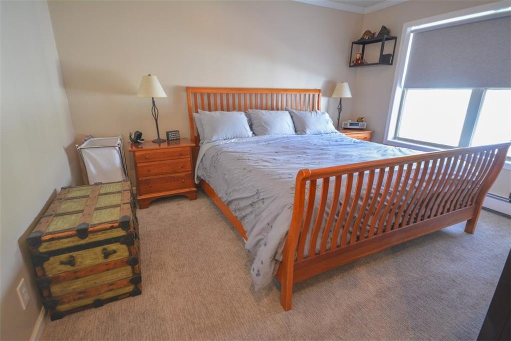 257 Huron Road, Unit E24 Breckenridge, CO 80424 - Photo 19 of 29 a bedroom with a bed and a night stand