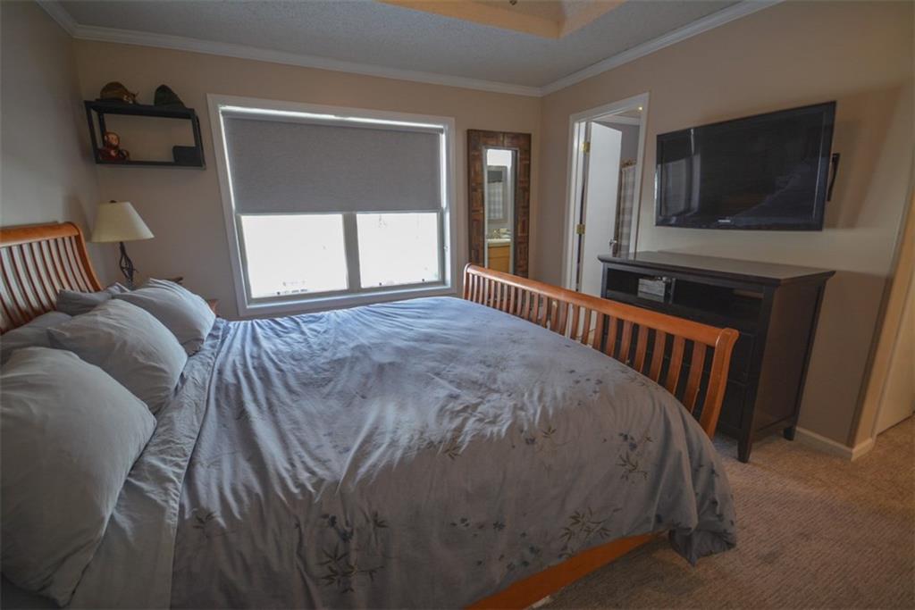 257 Huron Road, Unit E24 Breckenridge, CO 80424 - Photo 20 of 29 a bed sitting in a bedroom next to a window