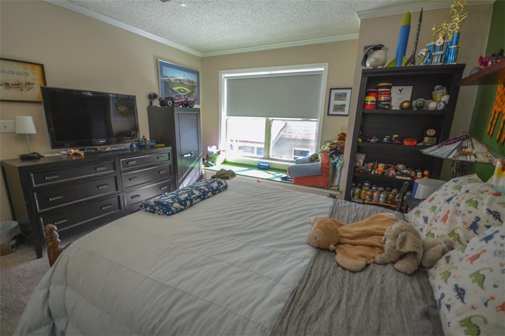 257 Huron Road, Unit E24 Breckenridge, CO 80424 - Photo 24 of 29 a bedroom with a bed and flat screen tv