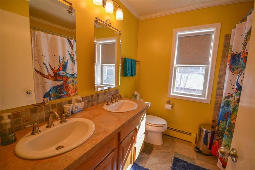 257 Huron Road, Unit E24 Breckenridge, CO 80424 - Photo 27 of 29 a bathroom with a double vanity sink and a mirror