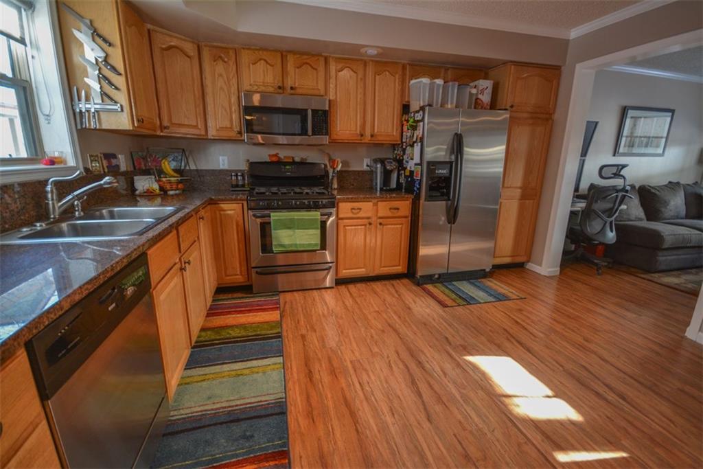 257 Huron Road, Unit E24 Breckenridge, CO 80424 - Photo 9 of 29 a kitchen with stainless steel appliances wooden floors and wooden cabinets