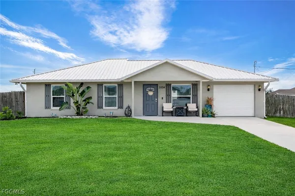 a view of a house with a backyard and porch