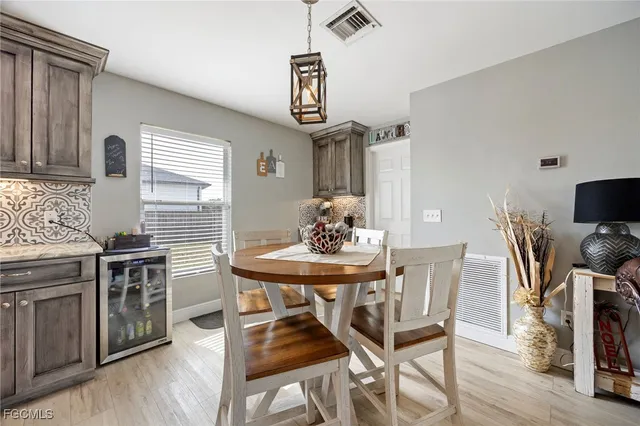a view of a dining room with furniture wooden floor and chandelier