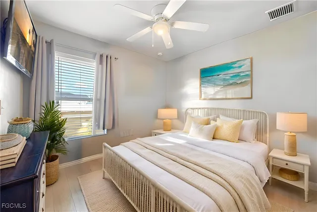 a bedroom with a bed and a painting on the wall