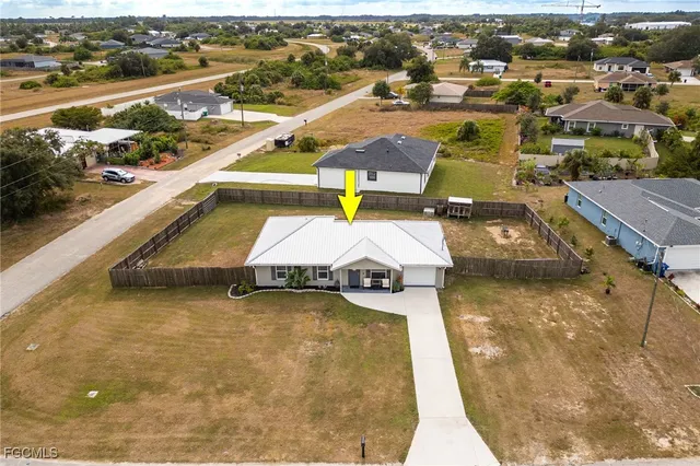 an aerial view of a house with swimming pool and ocean view