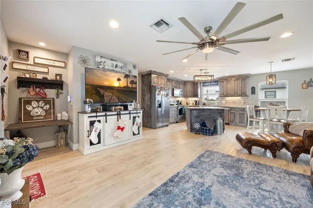 a living room with furniture and kitchen view