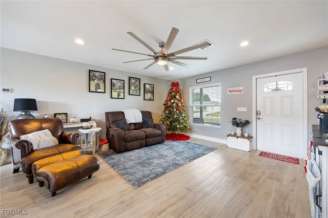 a living room with furniture a rug and a chandelier