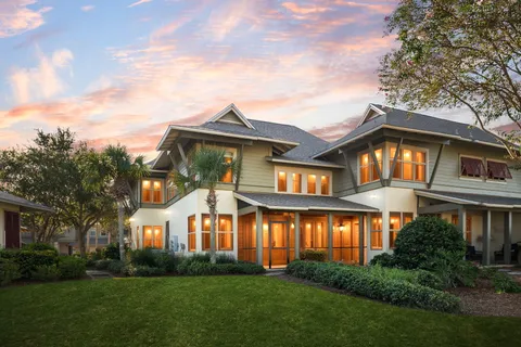 a front view of a house with a garden and plants