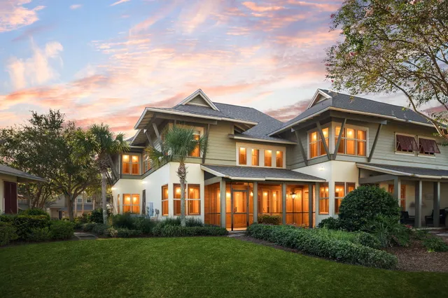 a front view of a house with a garden and plants