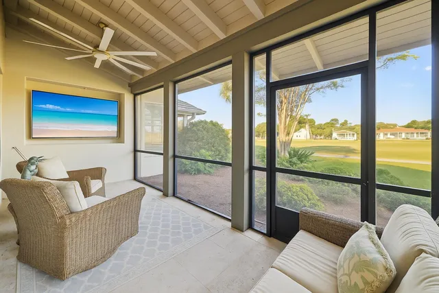 a living room with furniture and a floor to ceiling window