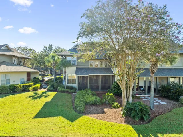 a front view of a house with yard and green space