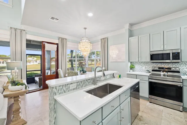a kitchen with a stove sink and microwave