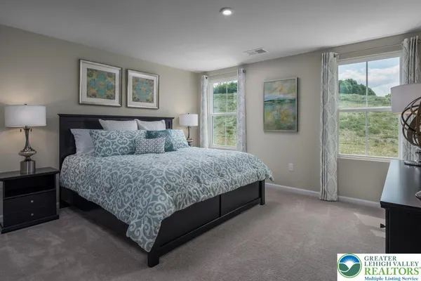 a spacious bedroom with a bed and a window