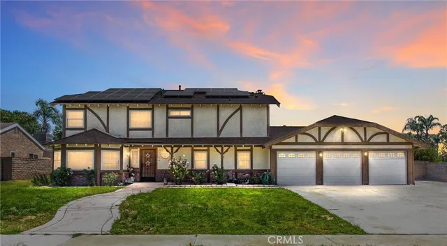 a front view of a house with yard and green space