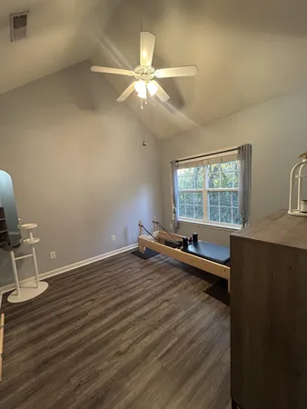 a view of a room with wooden floor and fan