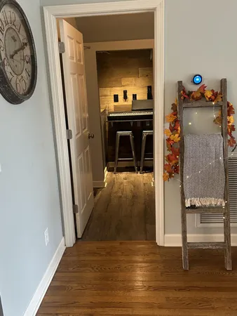 a view of a hallway view with wooden floor and closet