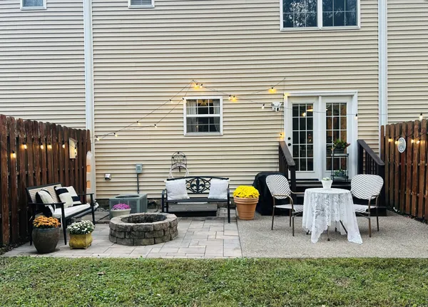 a view of backyard with patio and outdoor seating