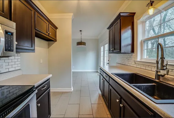 a kitchen that has a sink and a stove