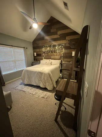 a bedroom with a bed a desk and chair