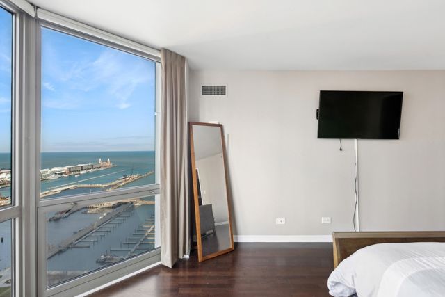 a living room with a flat screen tv and a floor to ceiling window