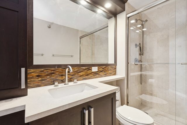 a bathroom with a sink toilet and shower