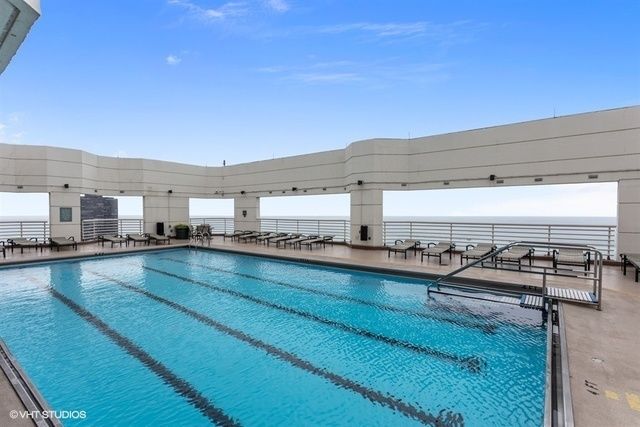 a view of a swimming pool with outdoor seating