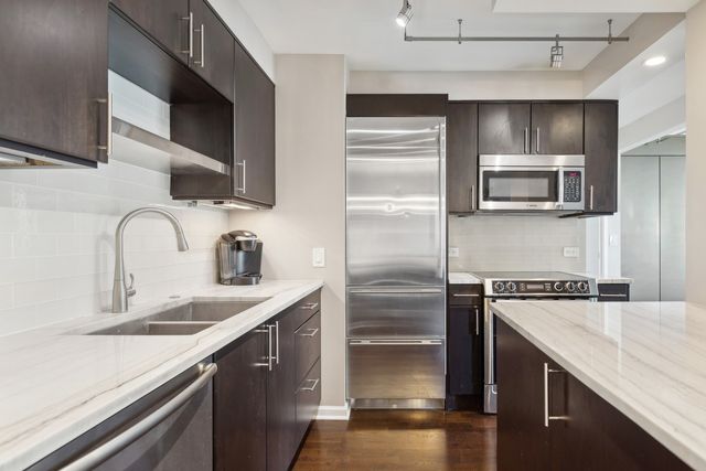 a kitchen with a sink microwave and refrigerator