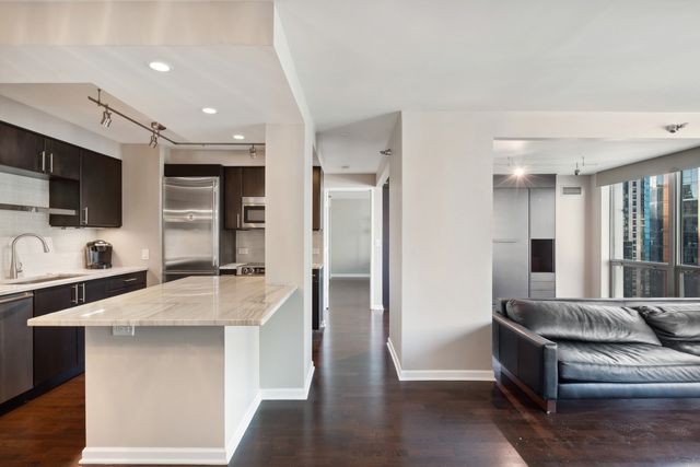a large white kitchen with a large window