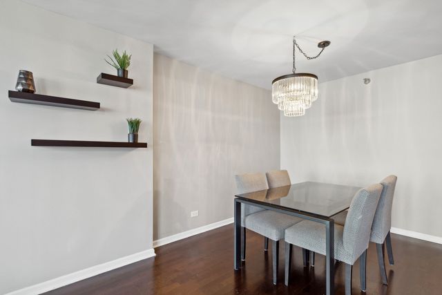 a view of a dining room with a table and chairs