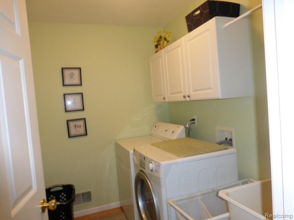 47976 Sandy Ridge Drive Macomb, MI 48044 - Photo 24 of 36 1st Floor Laundry Room, Washer and Dryer included, Laundry Tub, Overhead Cabinets and Drying Rod. Hard Wood Floors