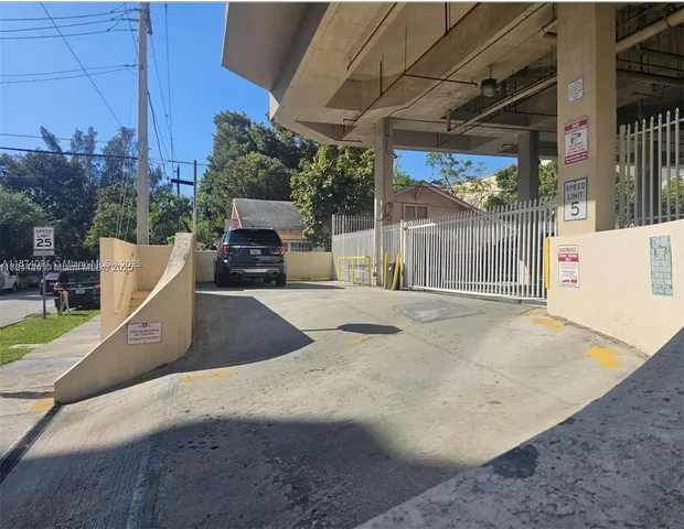 a view of a white house with a large park