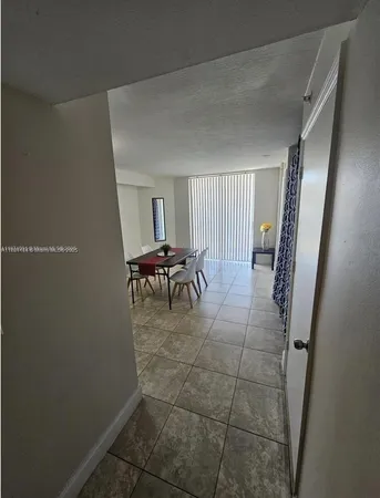 a dining room with furniture and a mirror