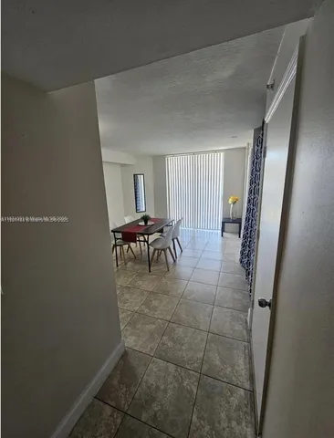 a dining room with furniture and a mirror